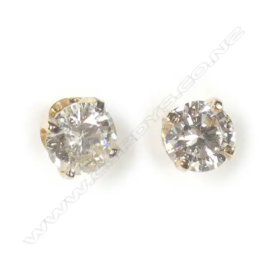 A pair of 9ct yellow gold solitaire diamond earrings