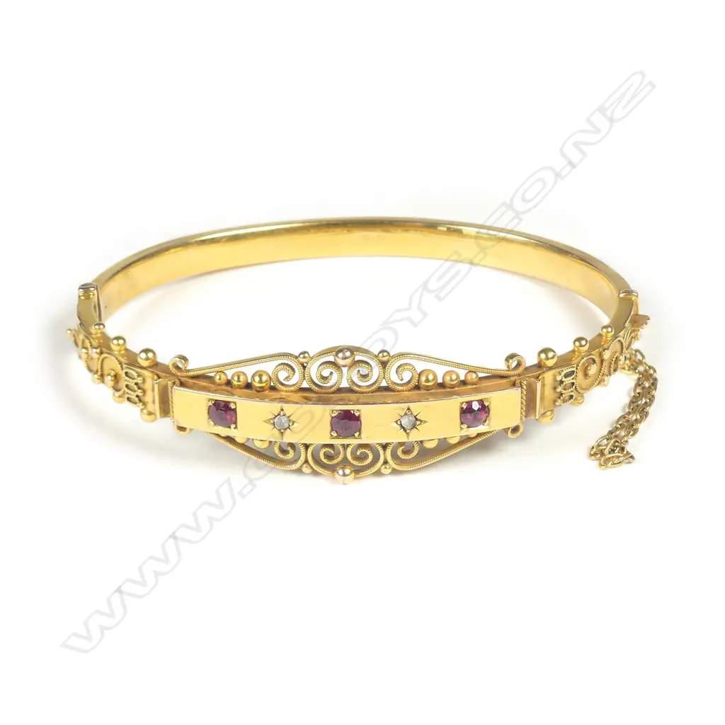 A Victorian 9ct gold diamond and ruby hinged bangle Image 1++