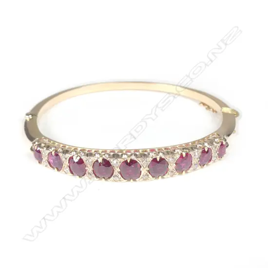 An Edwardian 15ct gold ruby and diamond hinged bangle