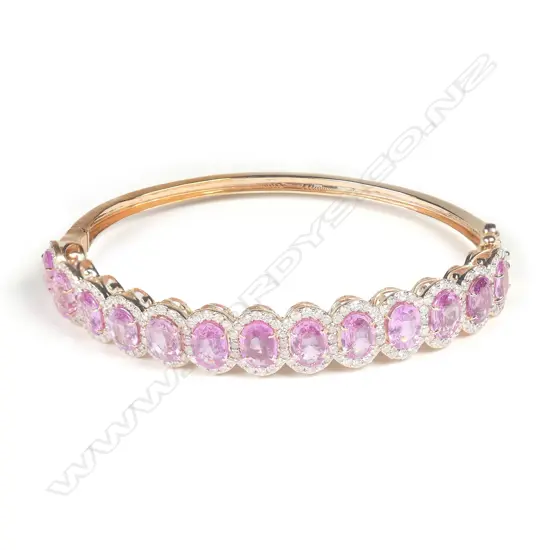 A 14ct rose gold pink sapphire and diamond halo bracelet