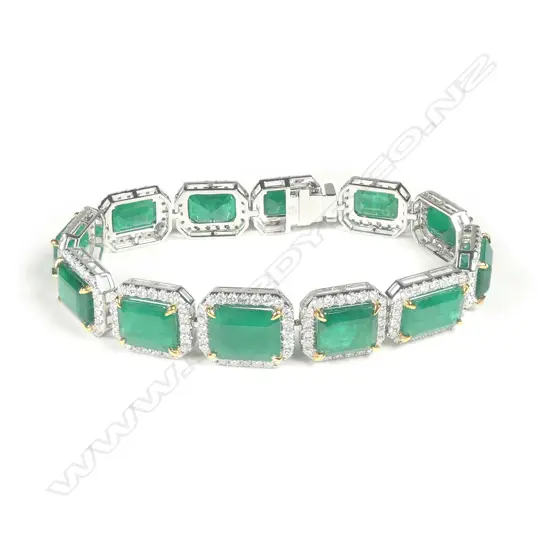 A platinum emerald and diamond halo bracelet