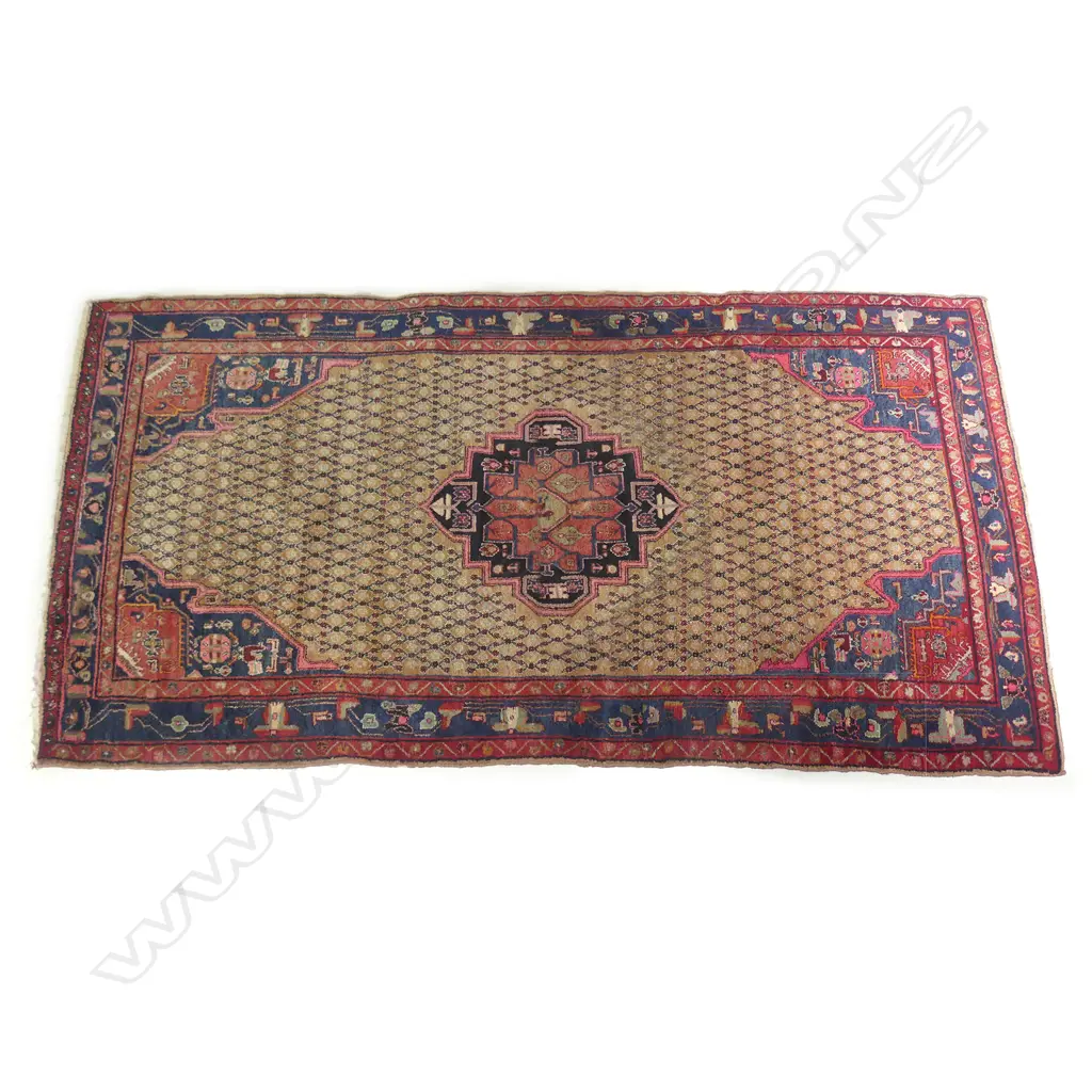 A large Persian carpet in traditional tones Image 1++