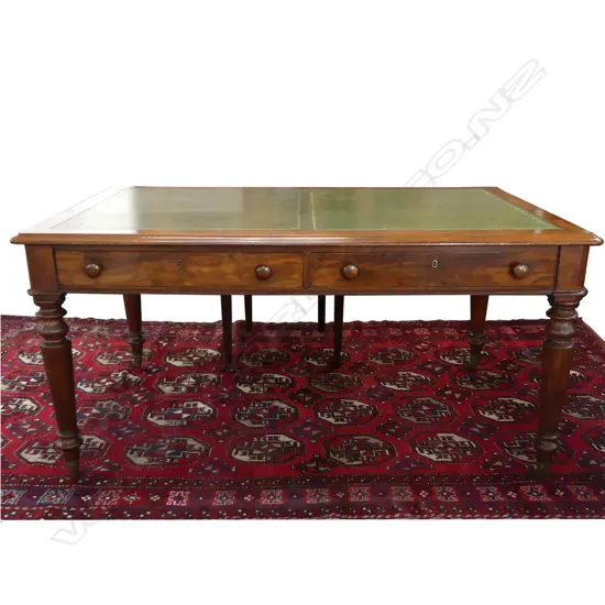 A Victorian oak or mahogany leather top library table