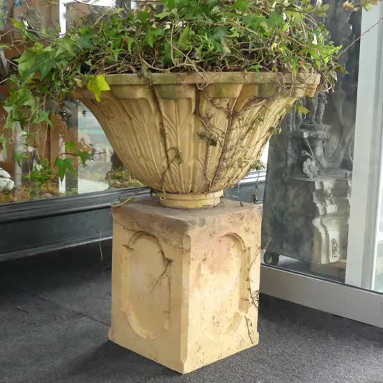 A large Tuscan style decorative garden planter