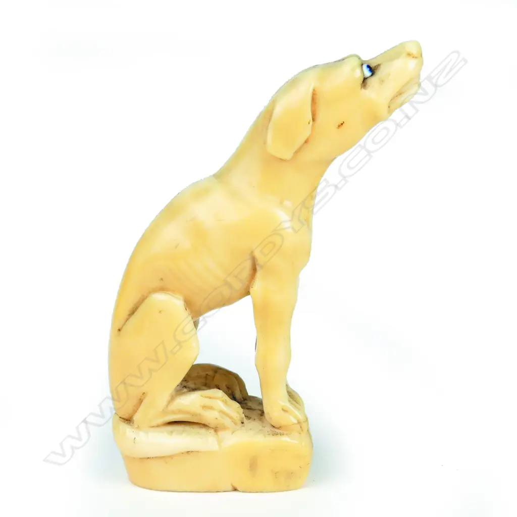 A 19thC marine ivory carving of a seated hound Image 1++