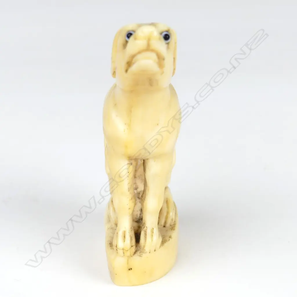 A 19thC marine ivory carving of a seated hound Image 1++