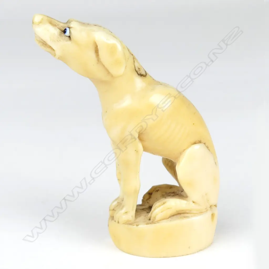 A 19thC marine ivory carving of a seated hound Image 1++