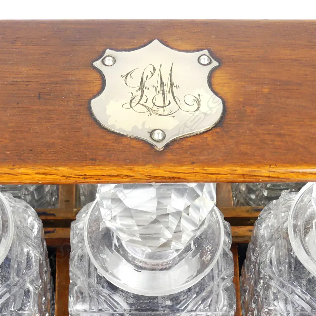 An Edwardian oak three-decanter tantalus Image 1++