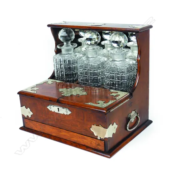 An Edwardian oak three-decanter tantalus