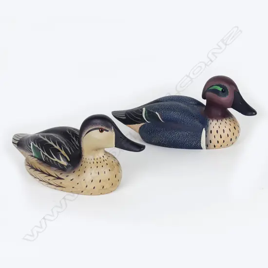 A pair of wooden teal duck decoys