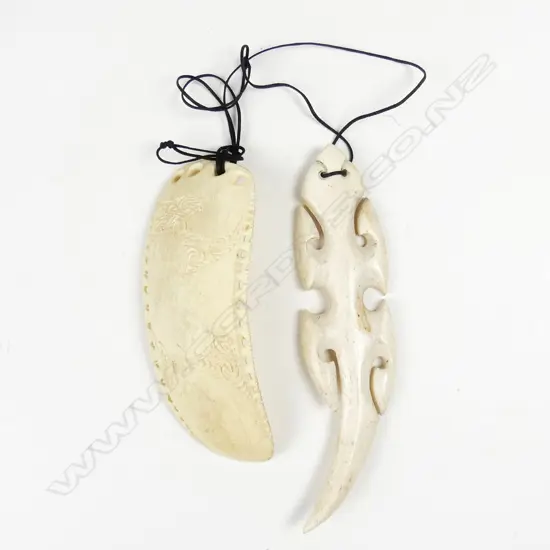 A carved bone lizard pendant