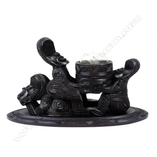 A rare late 19th early 20thC Maori carved kauri figure supported inkwell