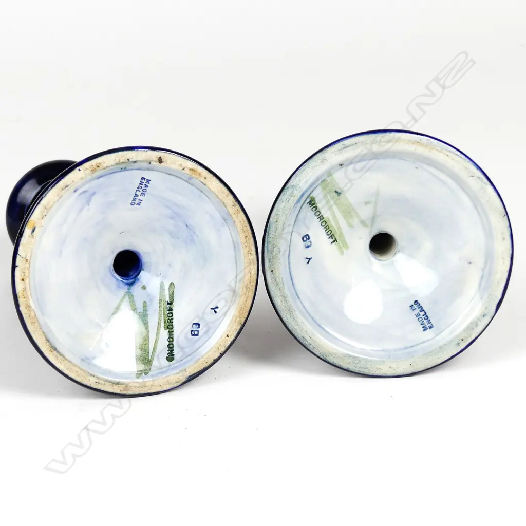 A pair of William Moorcroft pomegranate decorated candlesticks Image 1++