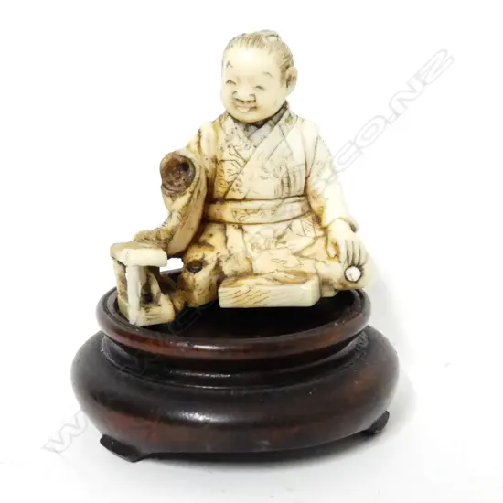 A small Japanese ivory carving of a young boy rat catcher