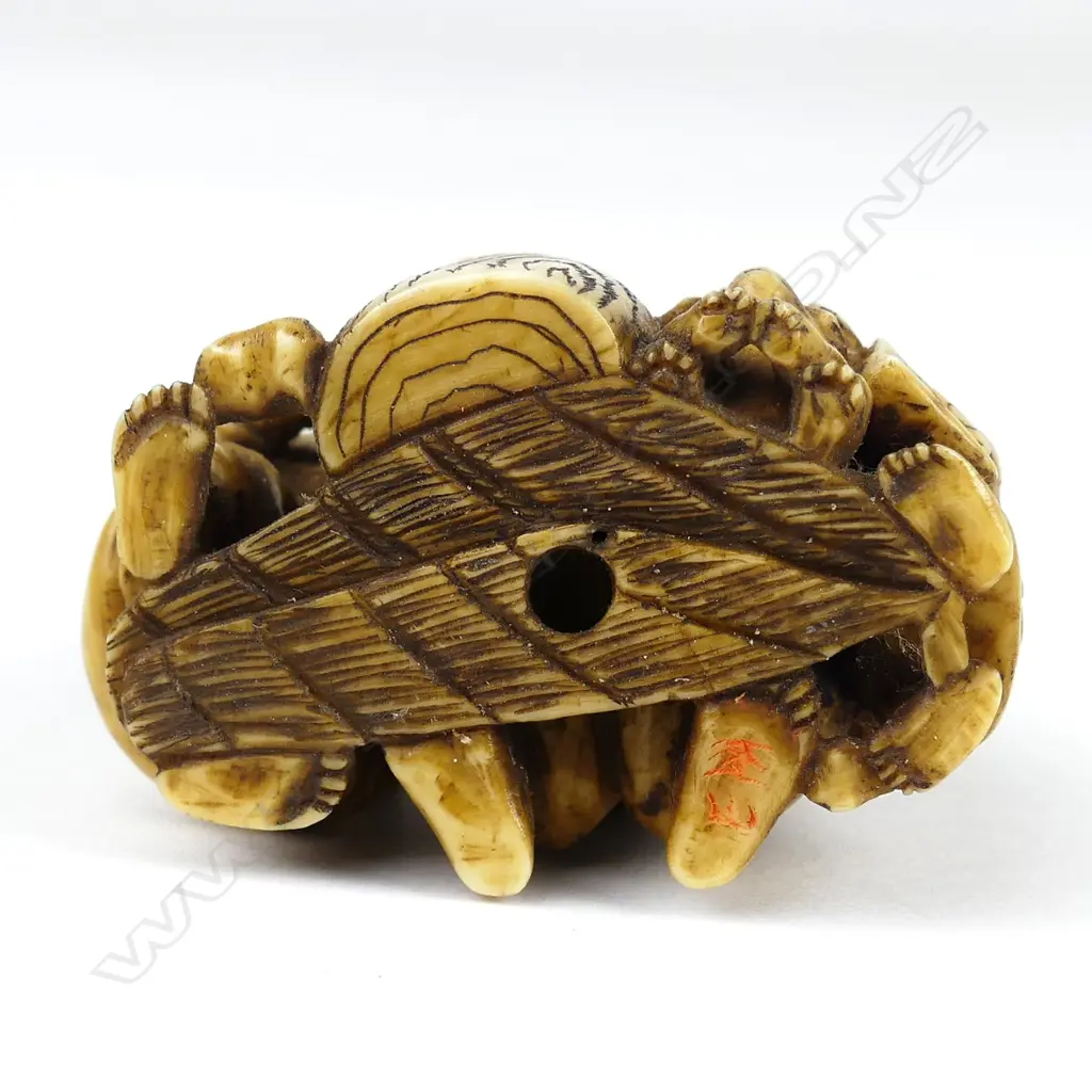 A Meiji period ivory netsuke of a family group pounding mochi (sticky rice cake) Image 1++
