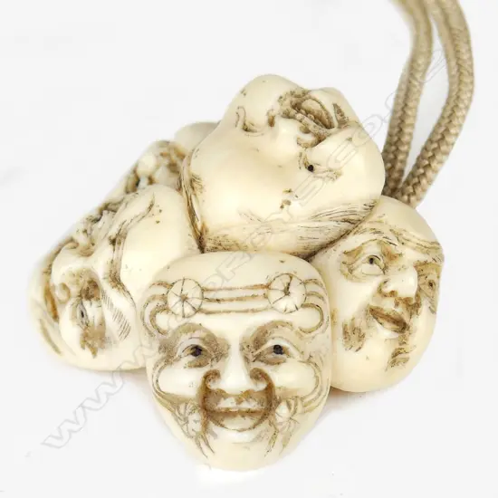 A Japanese ivory netsuke of a group of five masks including Okame