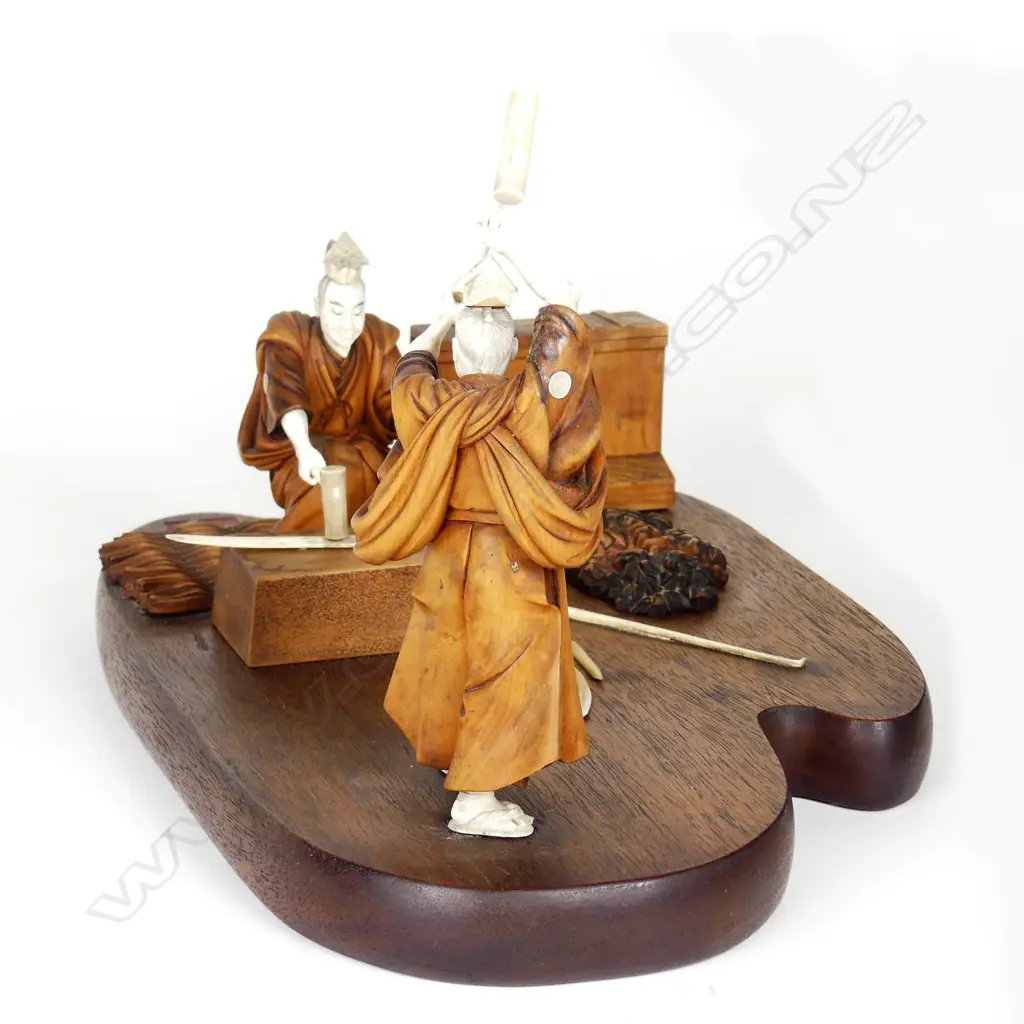 A Japanese Meiji period boxwood and ivory okimono of two swordsmiths Image 1++