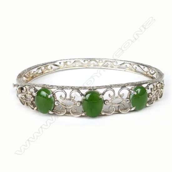 A silver and pounamu hinged bangle