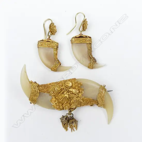 A c.1900 fancy high carat gold mounted double tiger's claw brooch and earring set