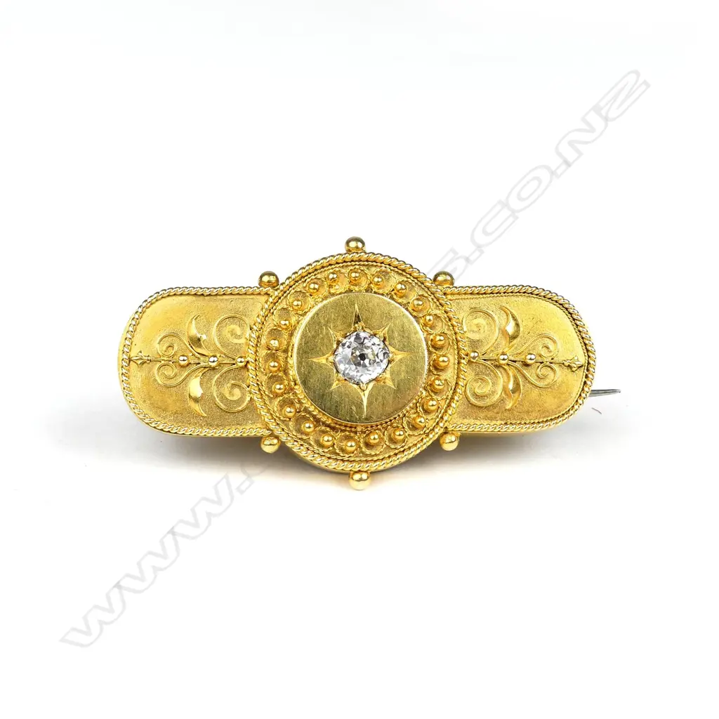 A late 19thC Etruscan heavy gold brooch set with a large diamond Image 1++