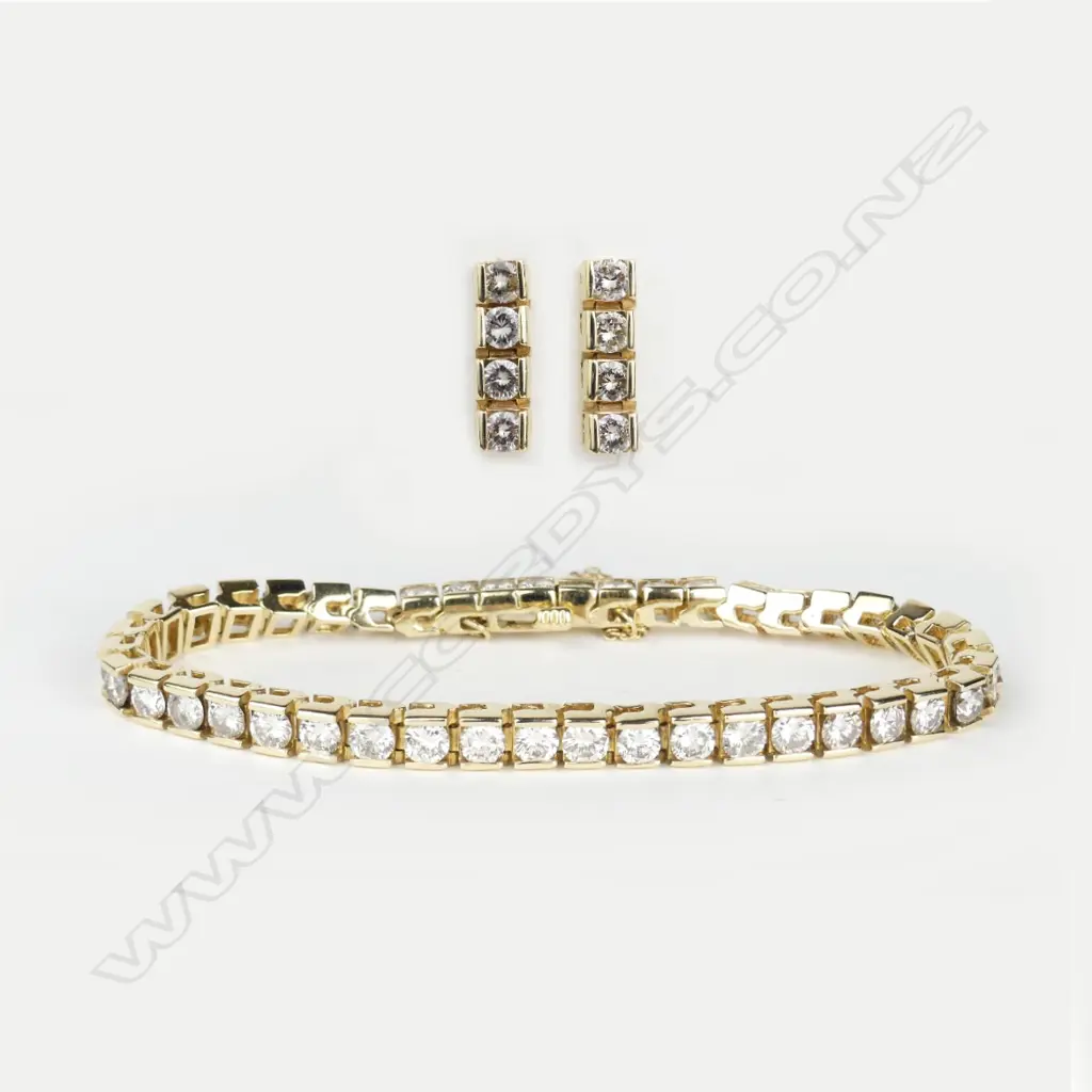 An 18ct yellow gold and diamond tennis bracelet and earring suite Image 1++