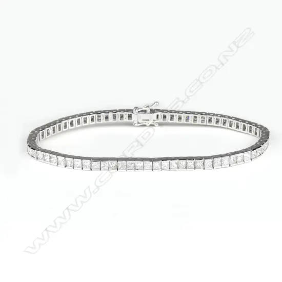 An 18ct. white gold and multi-diamond tennis bracelet