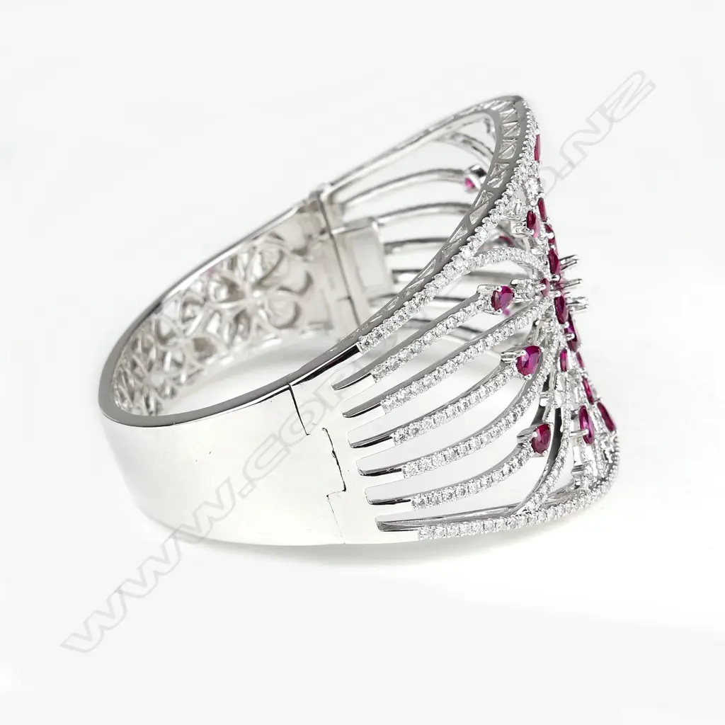 A spectacular 18ct. white gold ruby and diamond wide bangle Image 1++