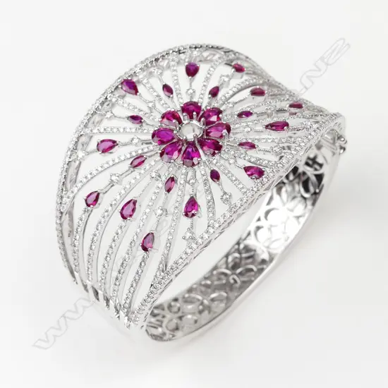 A spectacular 18ct. white gold ruby and diamond wide bangle