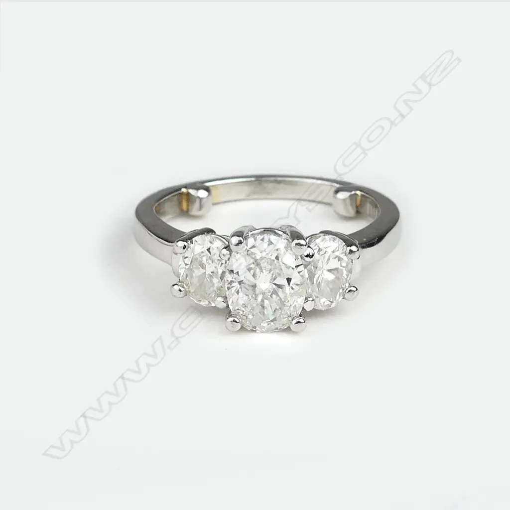 A modern three stone diamond set platinum ring Image 1++