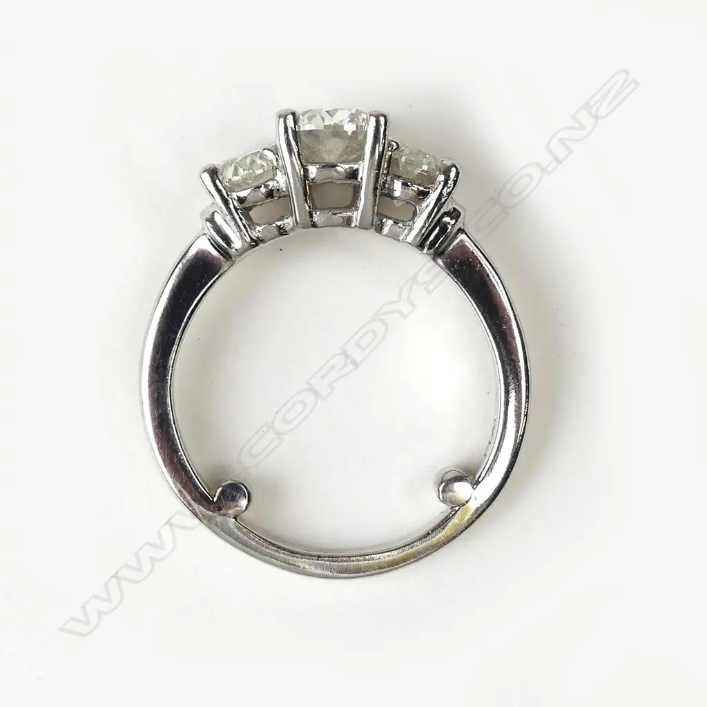 A modern three stone diamond set platinum ring Image 1++