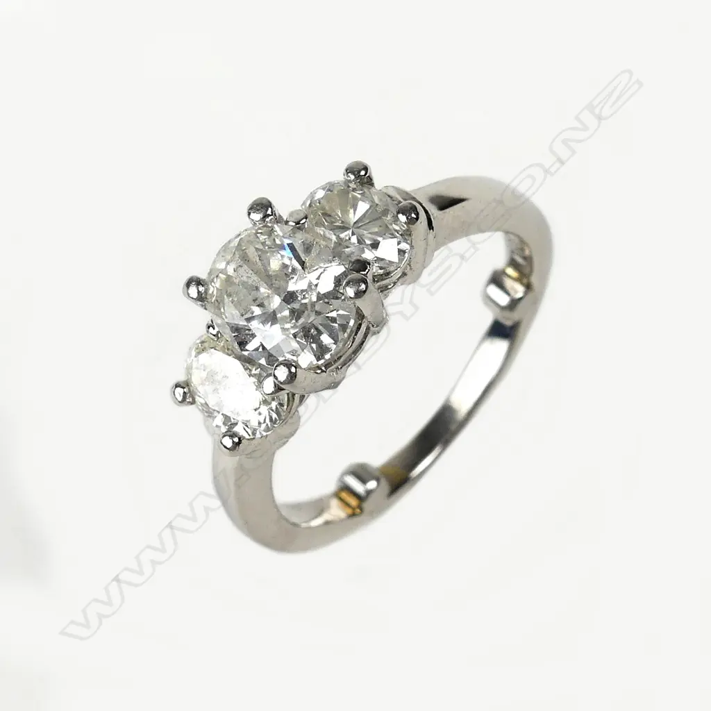 A modern three stone diamond set platinum ring Image 1++