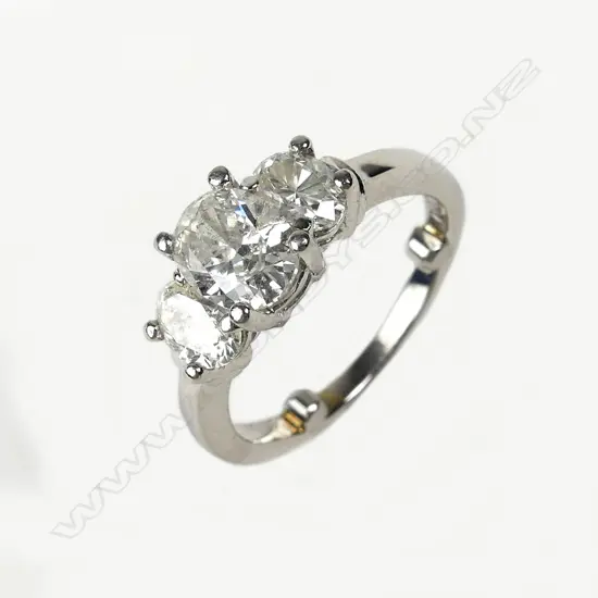 A modern three stone diamond set platinum ring