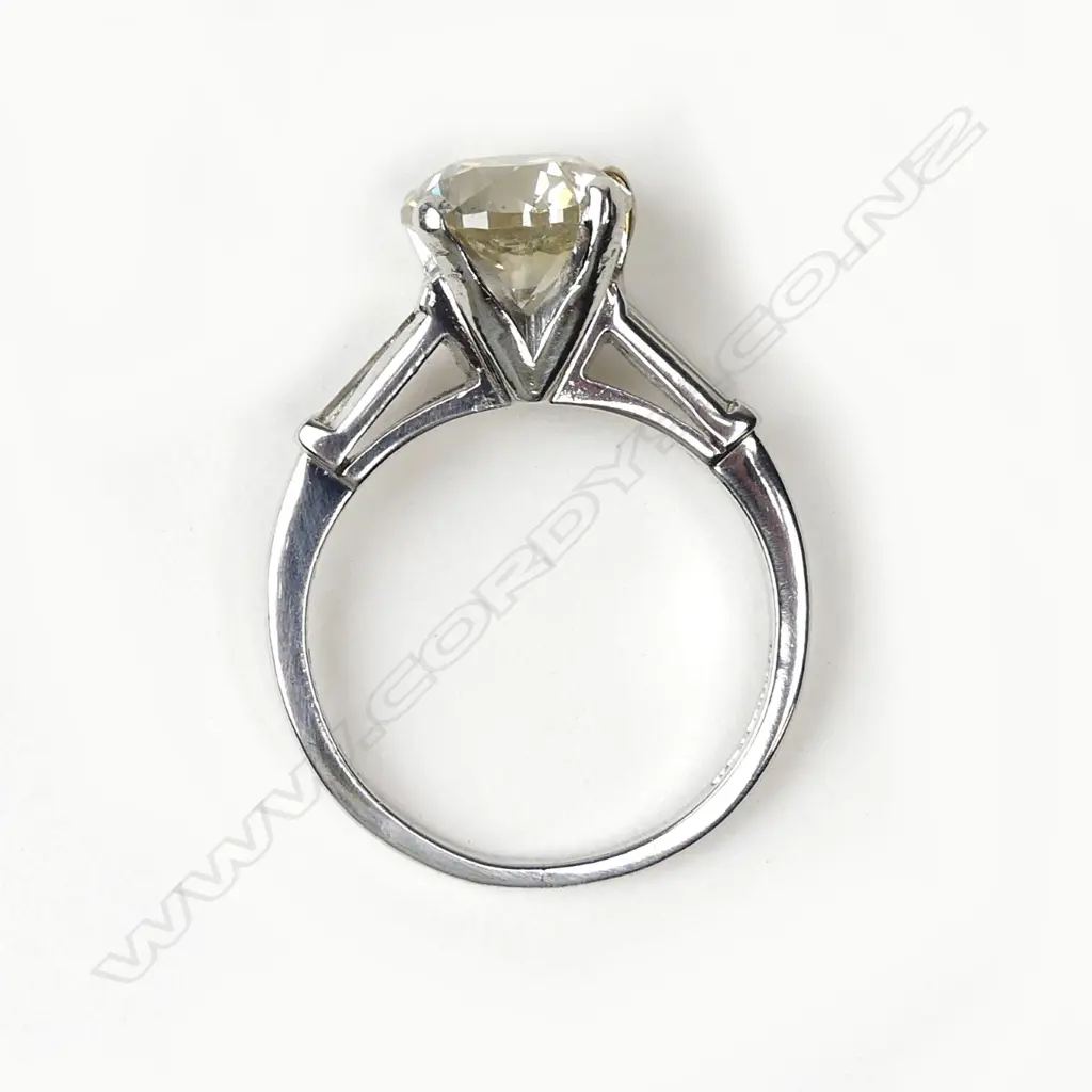 A platinum and diamond solitaire ring Image 1++