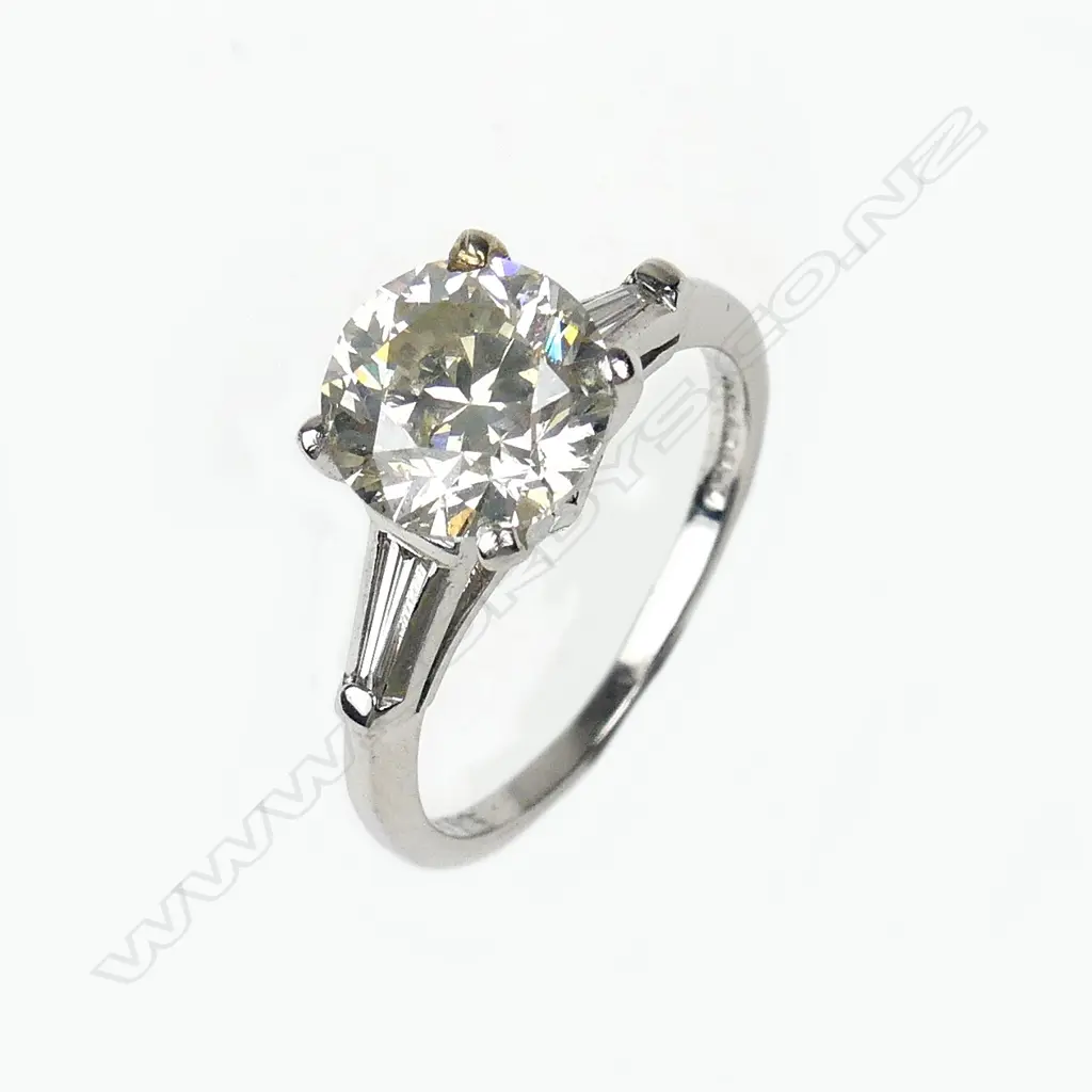 A platinum and diamond solitaire ring Image 1++