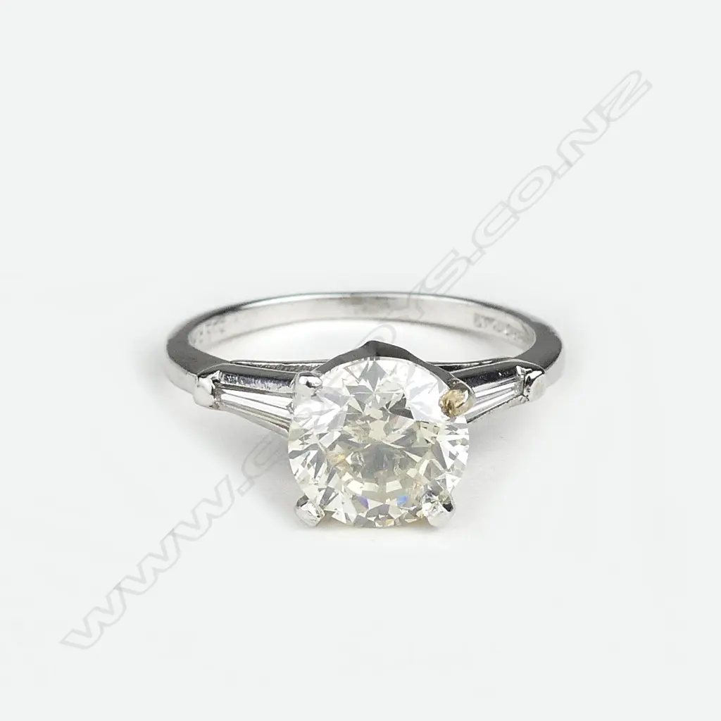 A platinum and diamond solitaire ring Image 1++