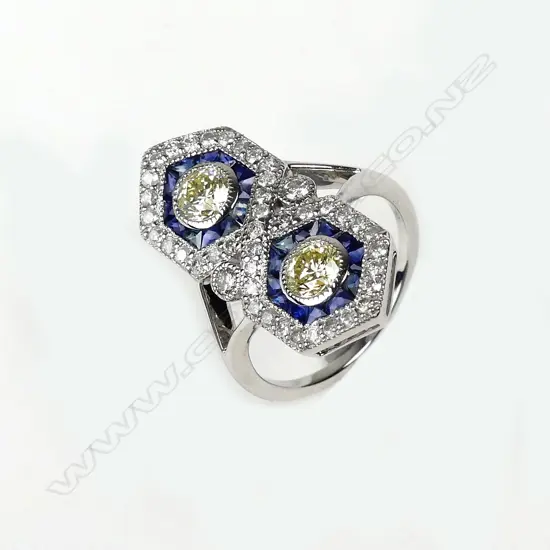 An 18ct. white gold diamond and sapphire Art Deco style ring
