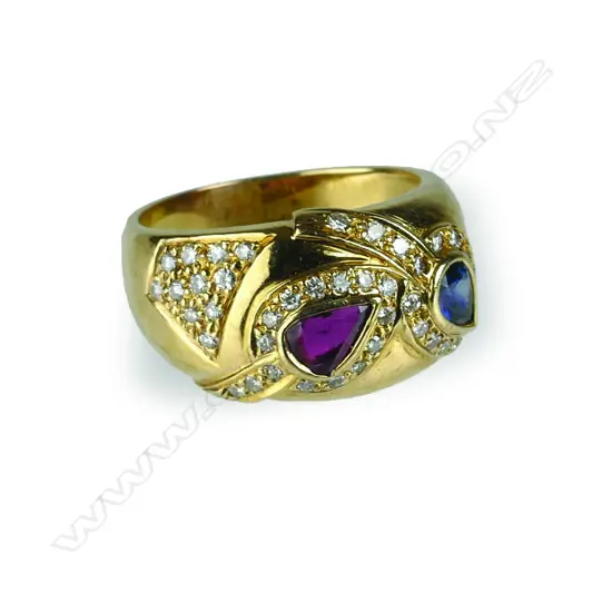 A modern 18ct. yellow gold ruby sapphire and diamond dress ring