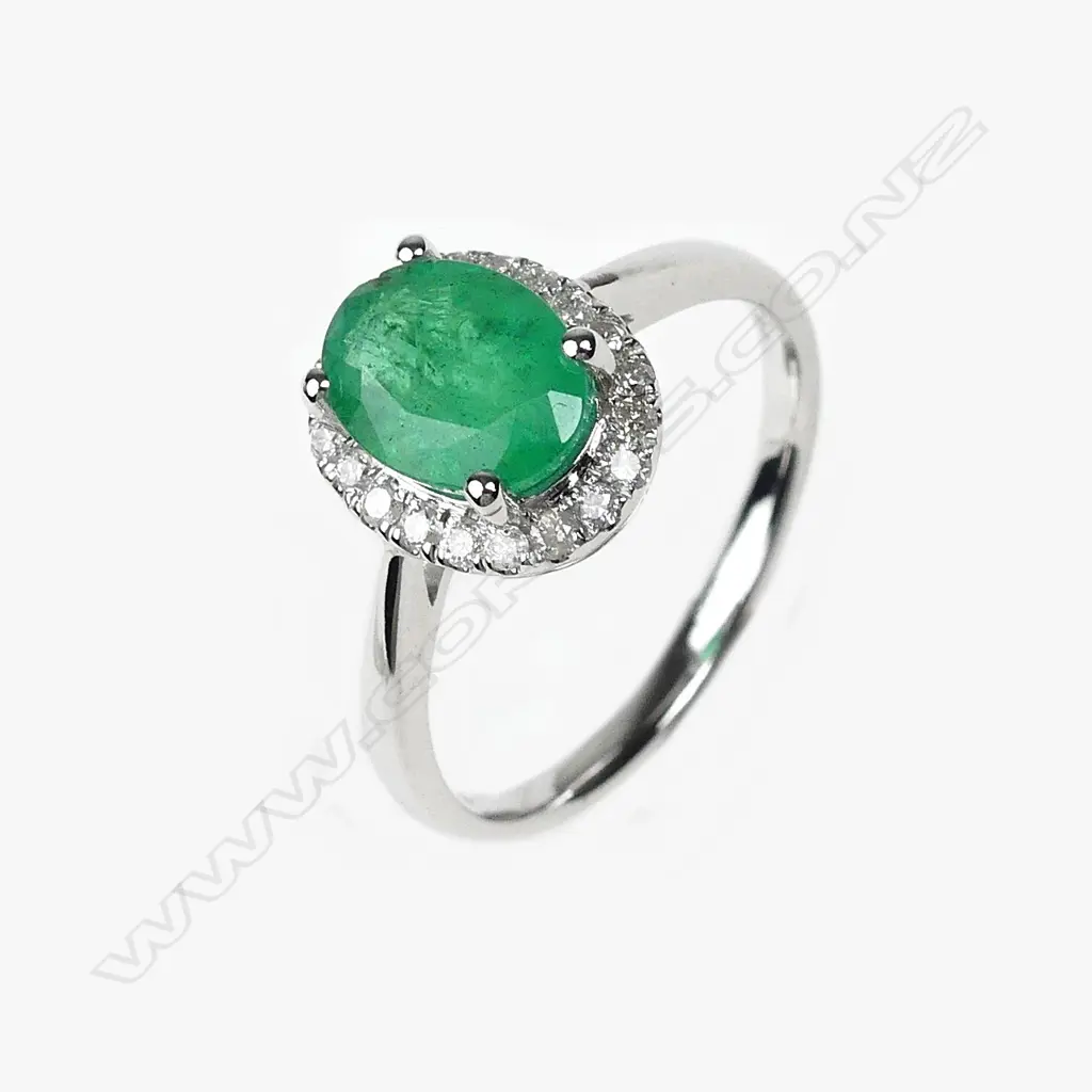A 14ct white gold emerald and diamond ring Image 1++