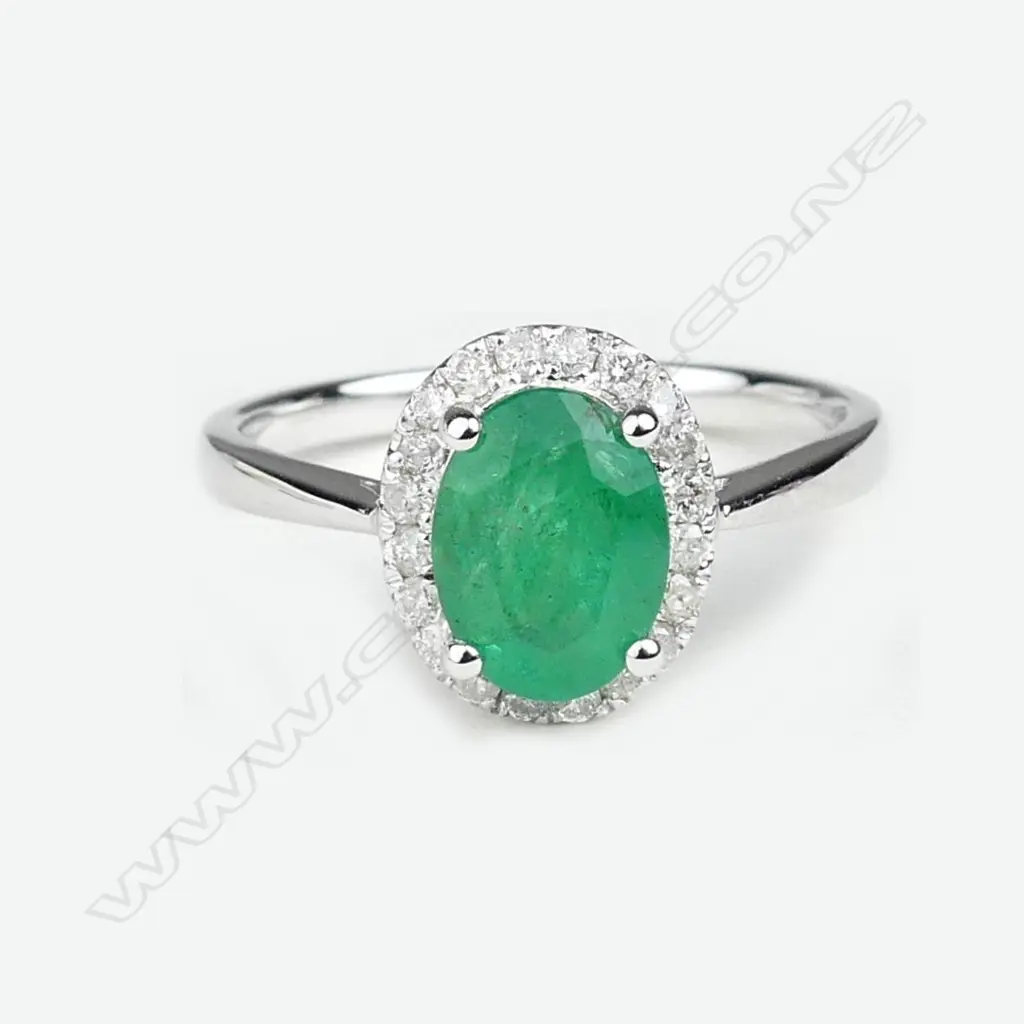 A 14ct white gold emerald and diamond ring Image 1++
