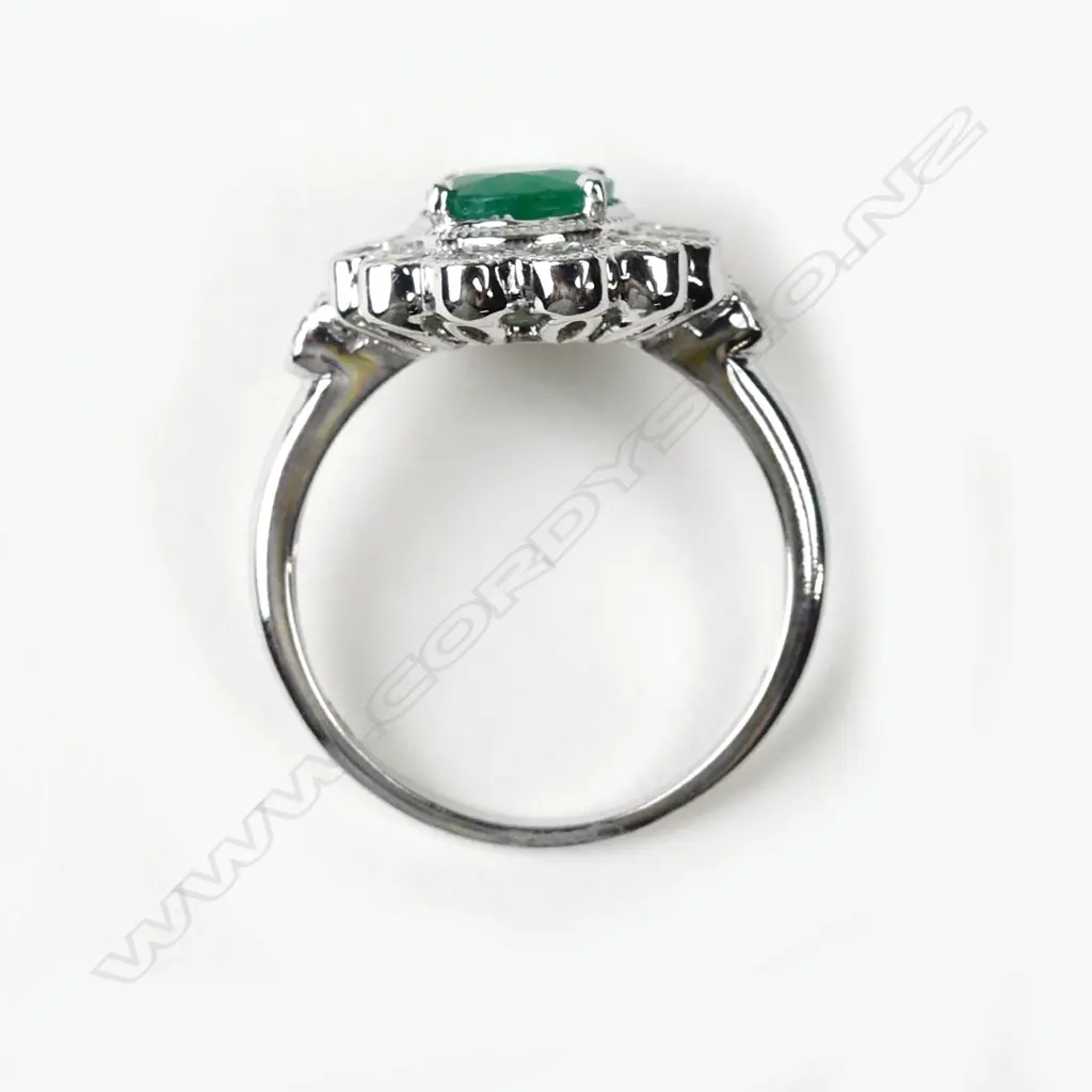 An 18ct white gold emerald and diamond ring Image 1++