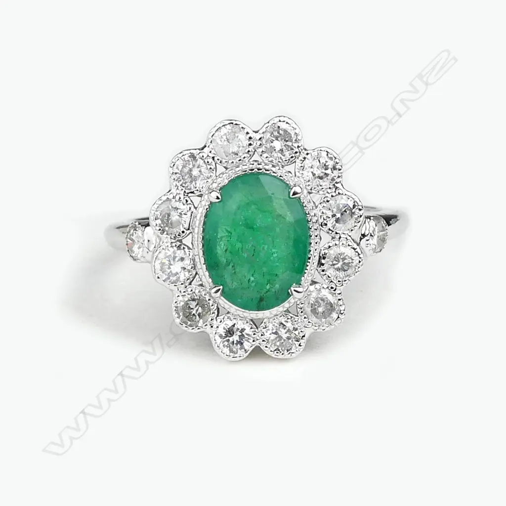 An 18ct white gold emerald and diamond ring Image 1++