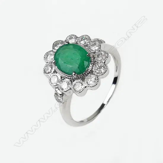 An 18ct white gold emerald and diamond ring