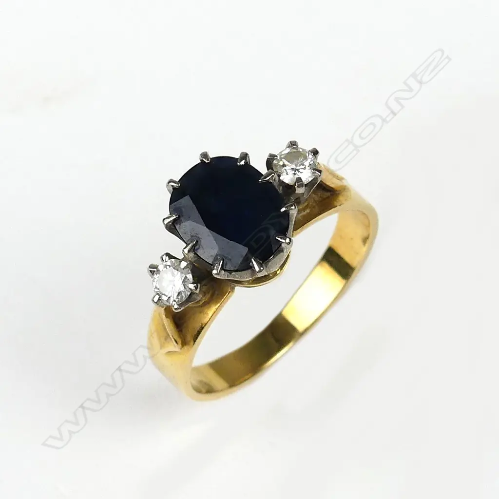 An 18ct. gold sapphire and two diamond ring Image 1++
