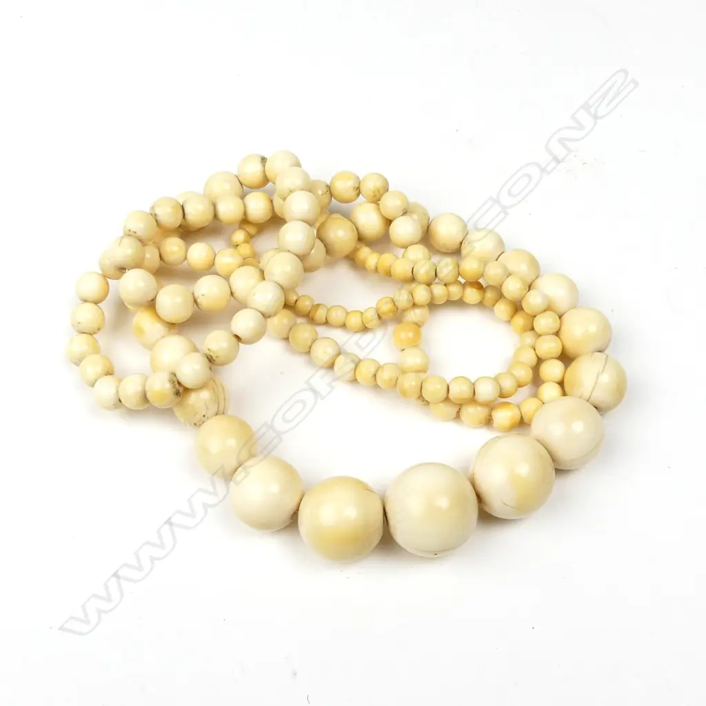 A long graduating strand of vintage spherical ivory beads Image 1++