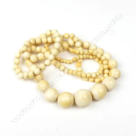 A long graduating strand of vintage spherical ivory beads