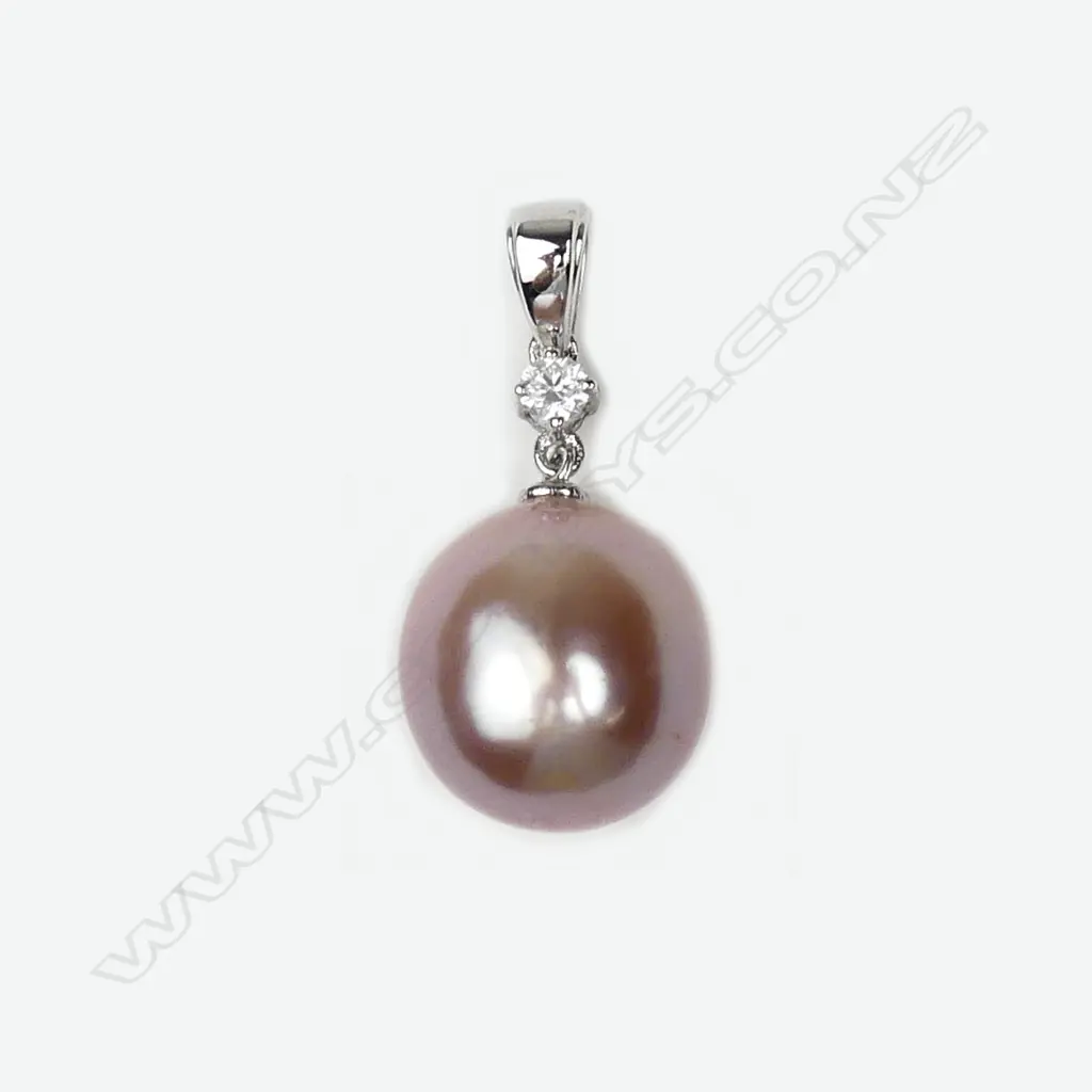A 14ct white gold pearl and diamond pendant Image 1++