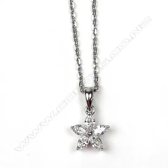 An 18ct. white gold and diamond star form pendant on an 18ct. fine chain