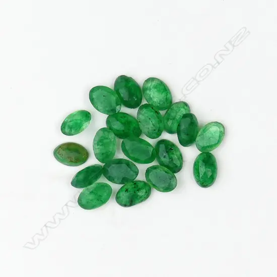 Nineteen loose oval facet cut emeralds