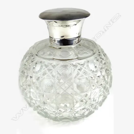 An Edwardian silver hinged lid cut crystal scent bottle
