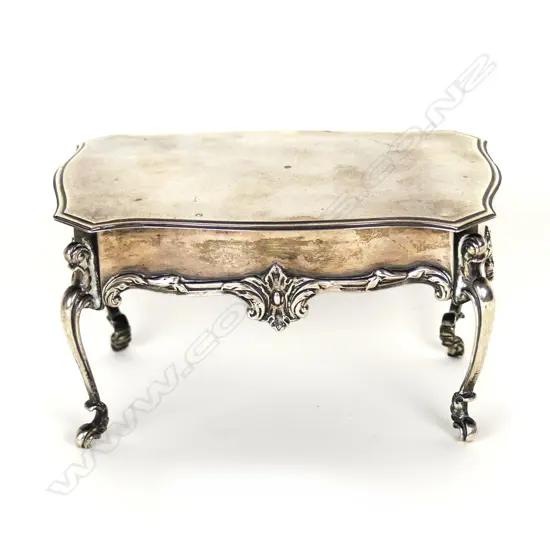 A small silver trinket box in the form of a French table